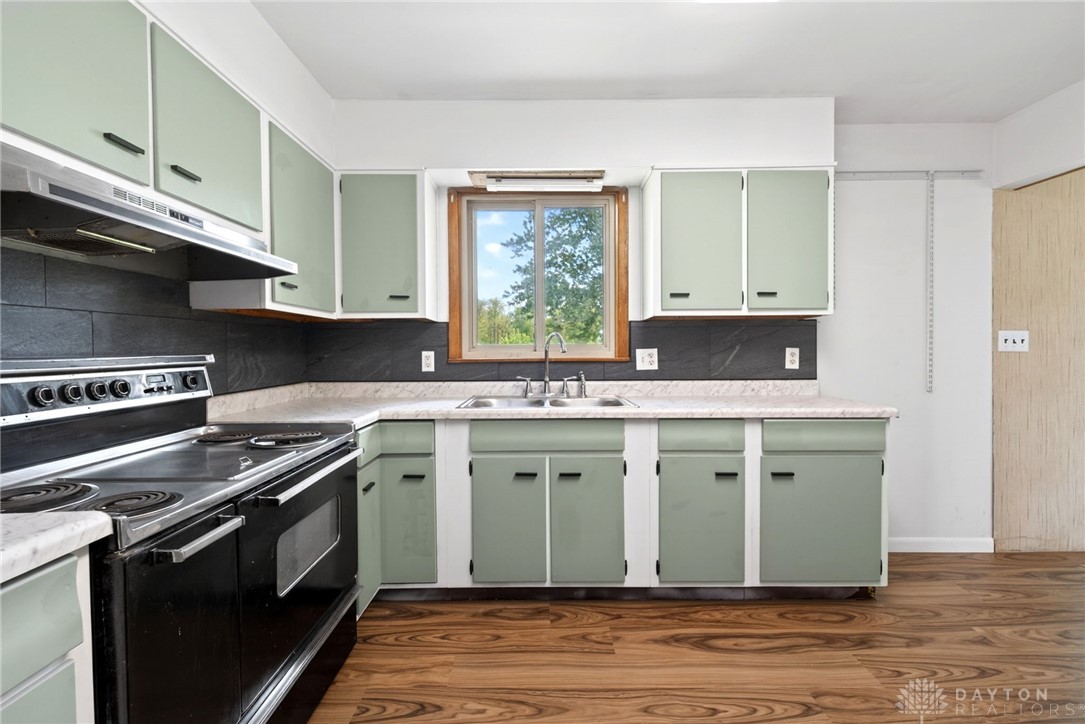 1005 Free Road New Carlisle, OH 45344 - Photo 16 of 43 This spacious kitchen offers ample cabinetry and counter space, perfect for culinary endeavors.