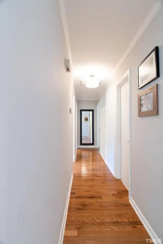 a view of a hallway with wooden floor