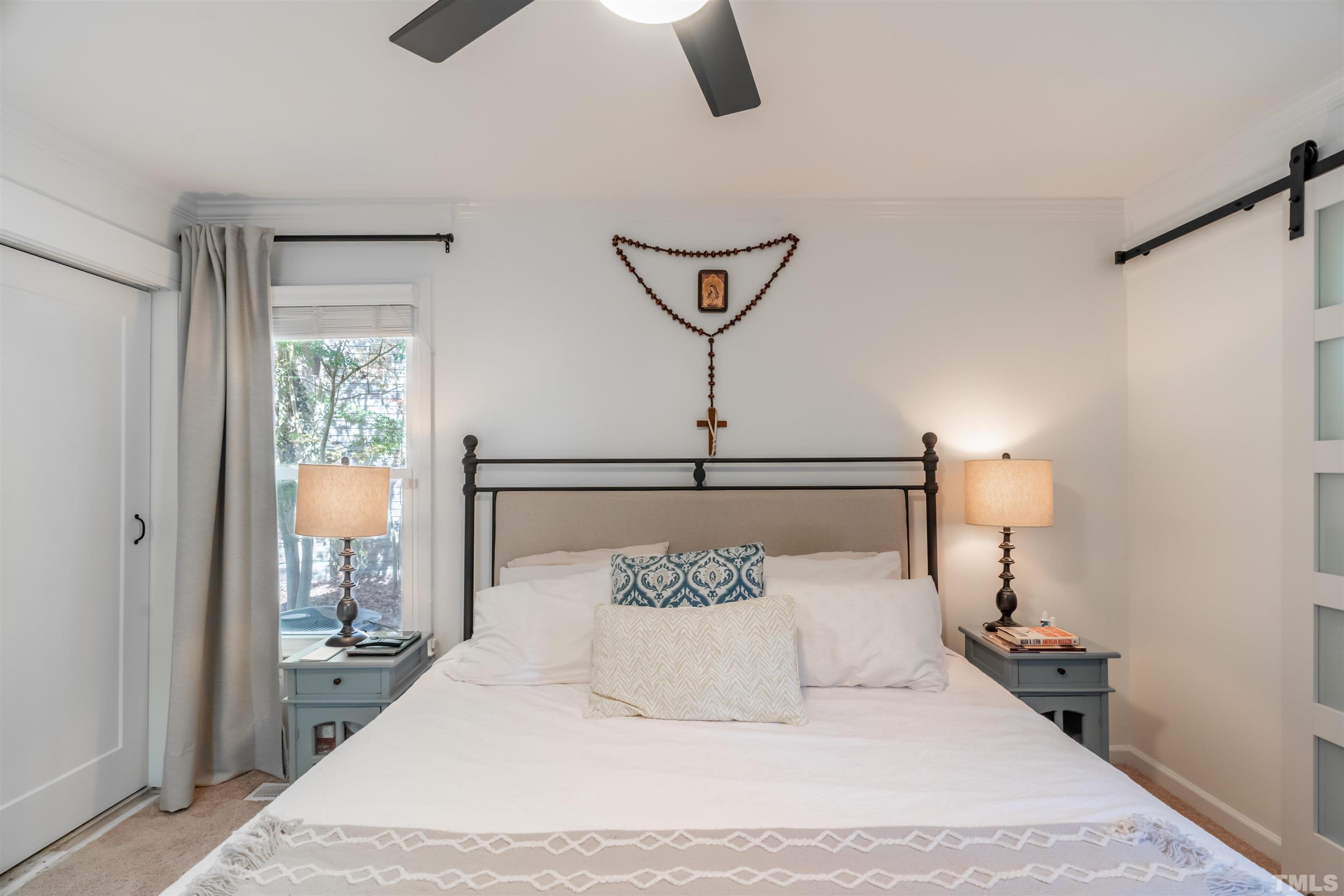 7304 Ray Road Raleigh, NC 27613 - Photo 19 of 30 a bedroom with a bed and a chandelier