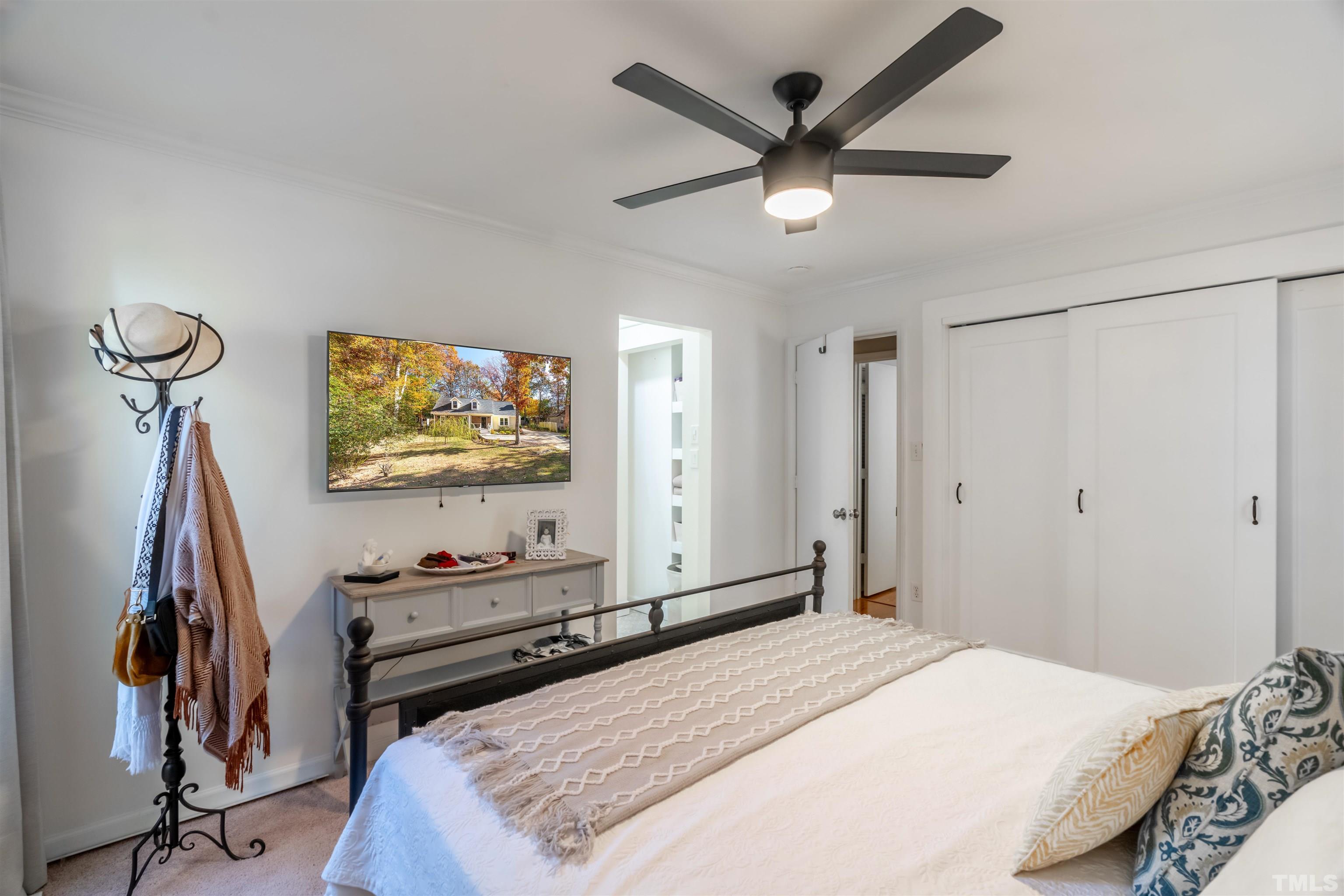 7304 Ray Road Raleigh, NC 27613 - Photo 20 of 30 a bedroom with a bed and a flat screen tv