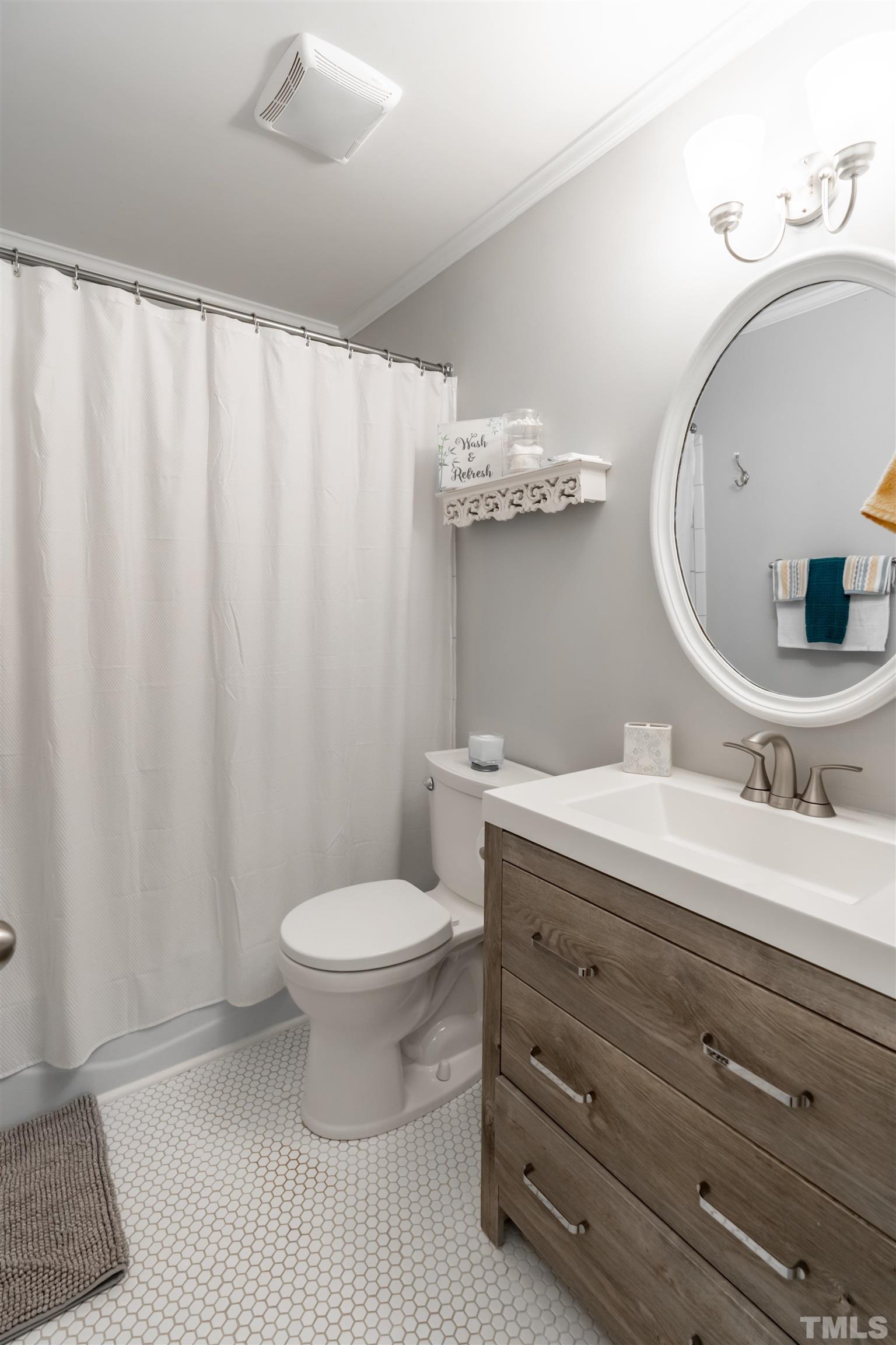 7304 Ray Road Raleigh, NC 27613 - Photo 21 of 30 a bathroom with a sink and a mirror