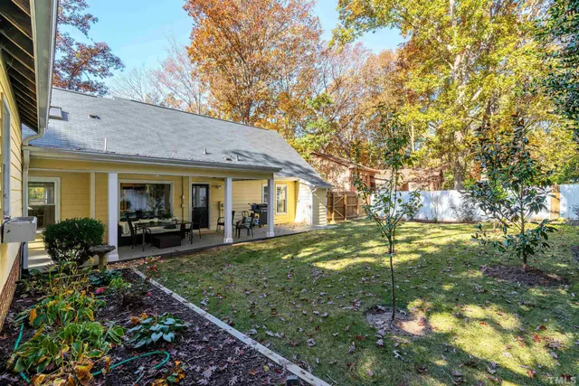 a view of a house with a yard patio and a yard