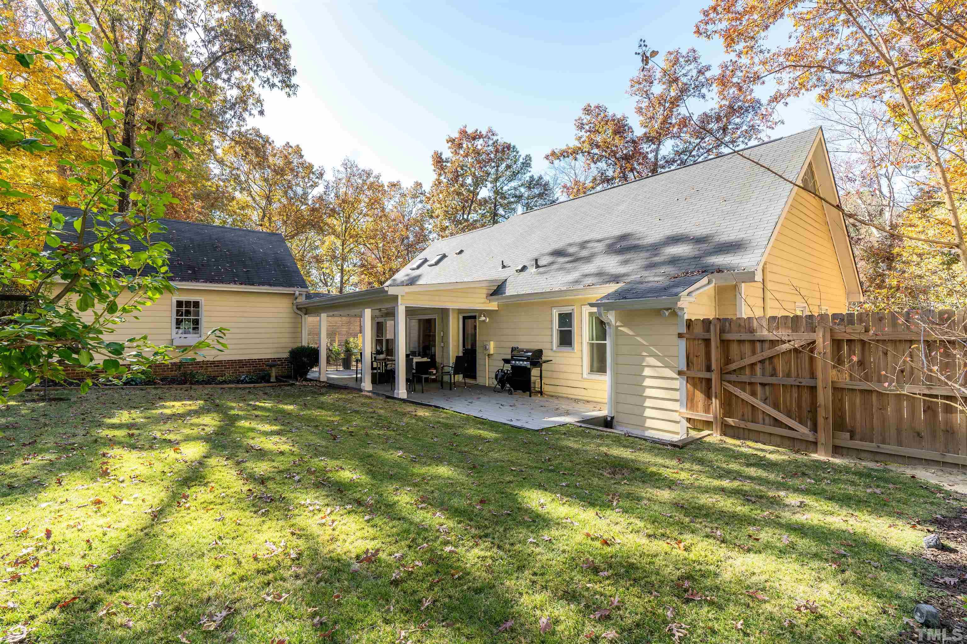 7304 Ray Road Raleigh, NC 27613 - Photo 29 of 30 a view of a house with a yard patio and a yard