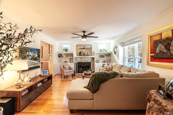 a living room with furniture a fireplace and a flat screen tv