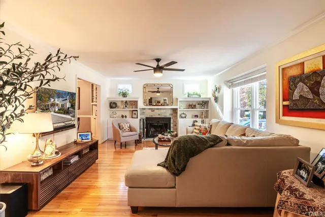 a living room with furniture a fireplace and a flat screen tv