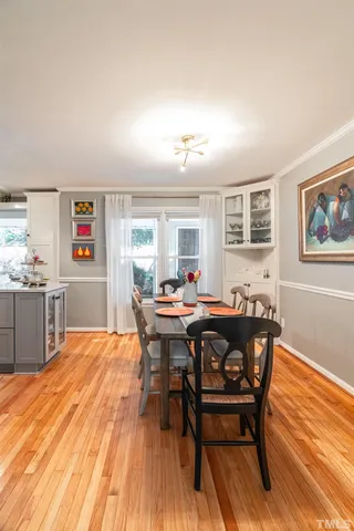 a view of a dining room with furniture and wooden floor