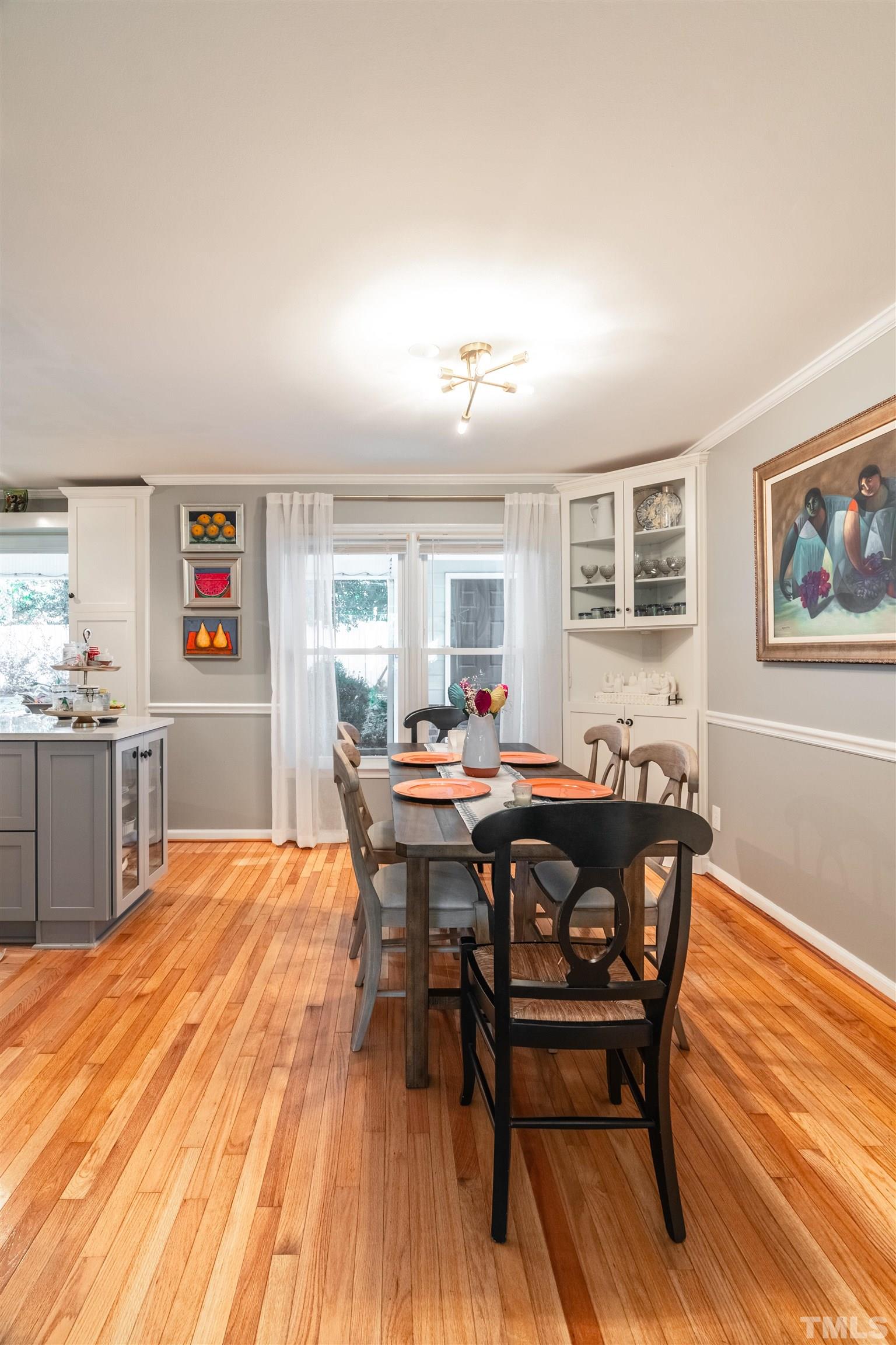 7304 Ray Road Raleigh, NC 27613 - Photo 6 of 30 a view of a dining room with furniture and wooden floor