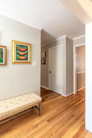 a spacious bedroom with a bed and painting on the wall