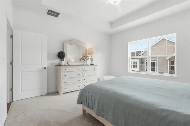 a spacious bedroom with a bed and a window