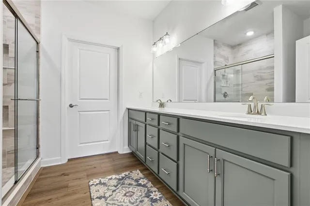 a bathroom with a double vanity sink and mirror