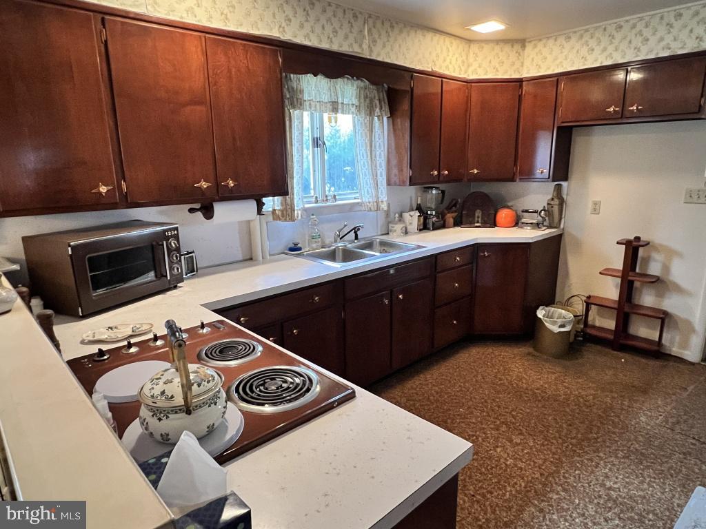977 Locust Grove Road Middletown, PA 17057 - Photo 22 of 30 a kitchen with a stove a sink and a microwave