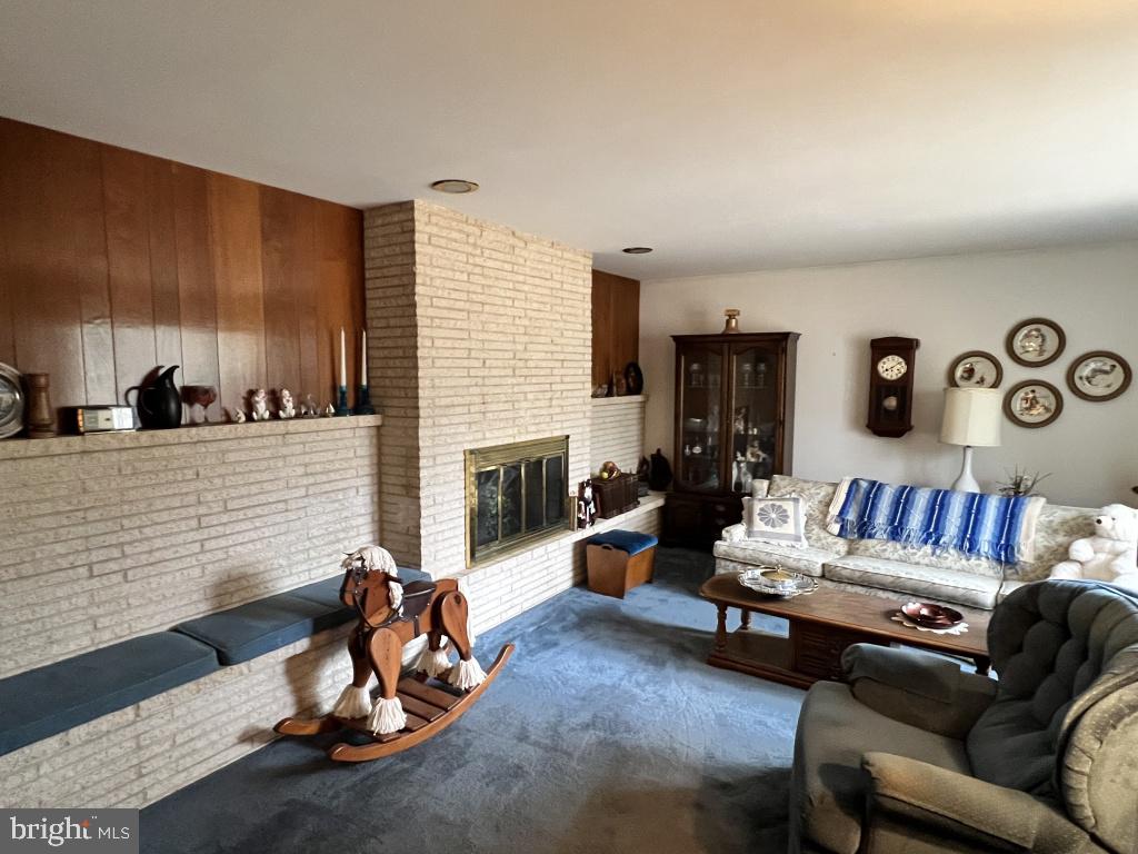 977 Locust Grove Road Middletown, PA 17057 - Photo 6 of 30 a living room with furniture a fireplace and a flat screen tv