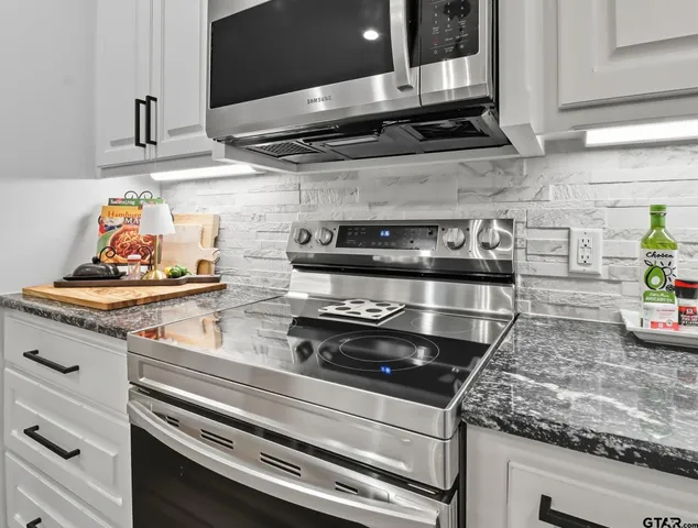 a stove top oven sitting inside of a kitchen
