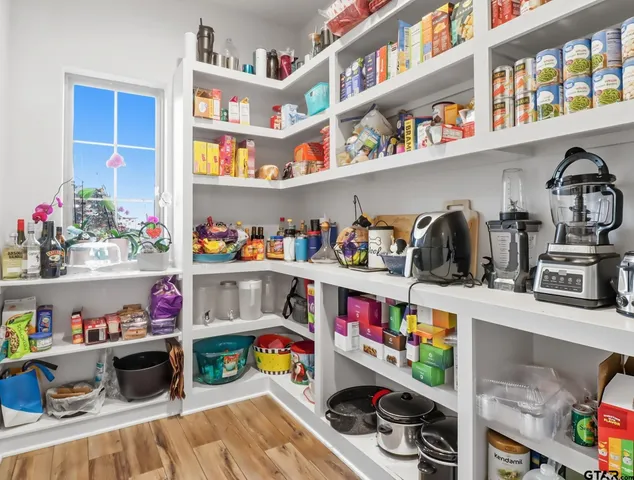 a utility room with lots of clutter and cabinets