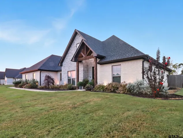 a front view of house with yard and green space
