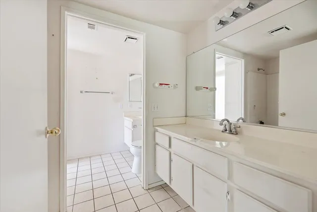 a bathroom with a sink and a mirror with toilet