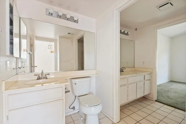 a bathroom with a toilet sink and a mirror