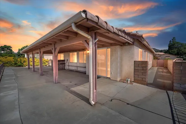 a view of a house with a wooden deck