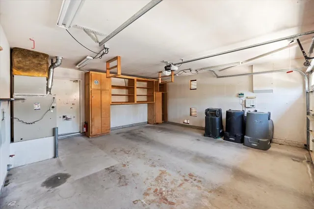 a view of a big room with refrigerator storage and windows