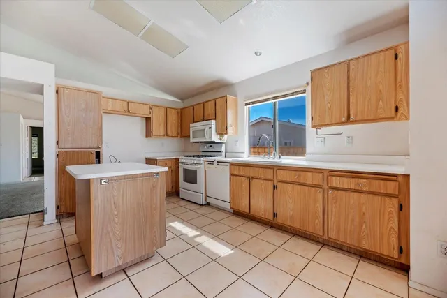 a kitchen with stainless steel appliances granite countertop a stove a sink and a window