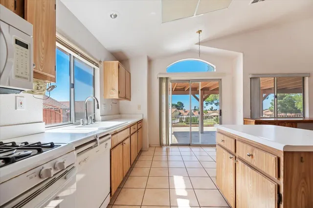 a kitchen with stainless steel appliances a sink stove and cabinets