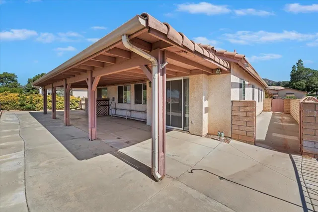a view of a house with wooden deck front of house