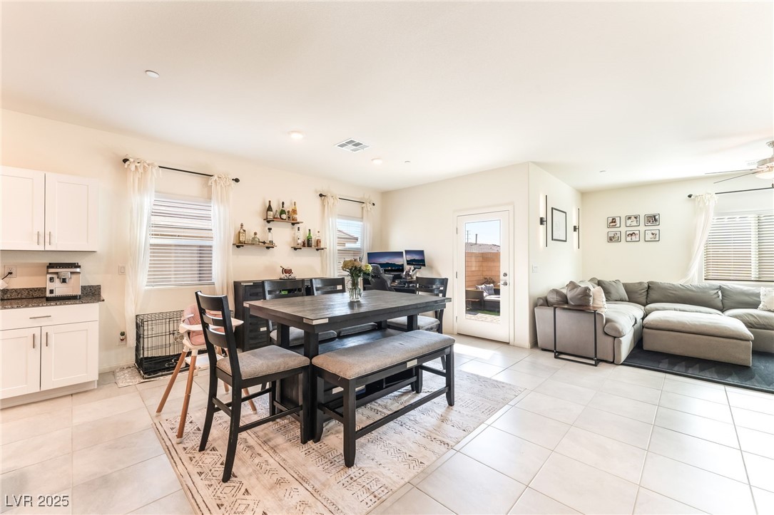 10947 Artisan Ranch Avenue Las Vegas, NV 89166 - Photo 11 of 39 Dining area featuring healthy amount of natural light, light tile patterned floors, and a ceiling fan