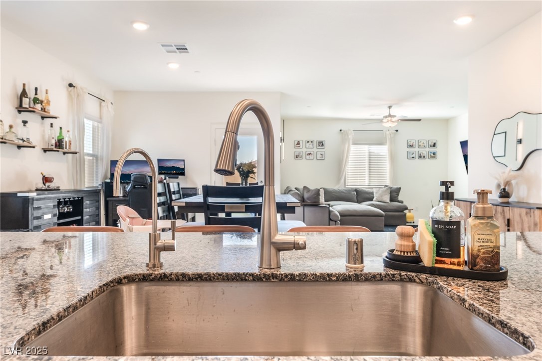 10947 Artisan Ranch Avenue Las Vegas, NV 89166 - Photo 39 of 39 Kitchen featuring open floor plan, dark stone countertops, plenty of natural light, a ceiling fan, and recessed lighting