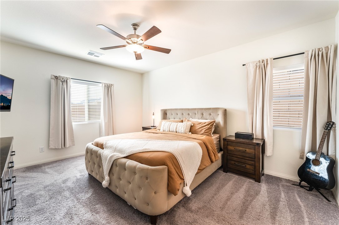 10947 Artisan Ranch Avenue Las Vegas, NV 89166 - Photo 15 of 39 Carpeted bedroom featuring a ceiling fan and baseboards