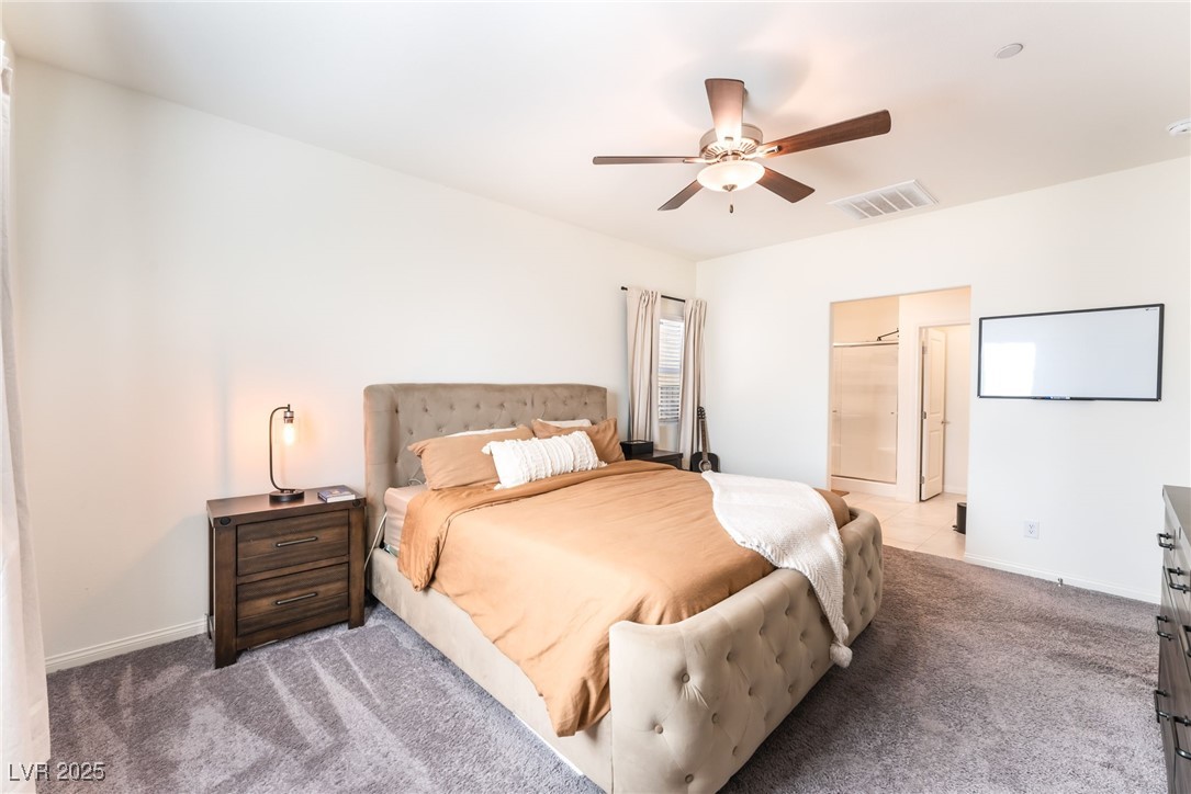 10947 Artisan Ranch Avenue Las Vegas, NV 89166 - Photo 16 of 39 Carpeted bedroom featuring ensuite bath and a ceiling fan