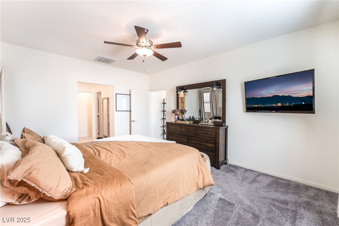10947 Artisan Ranch Avenue Las Vegas, NV 89166 - Photo 17 of 39 Bedroom featuring light colored carpet and a ceiling fan
