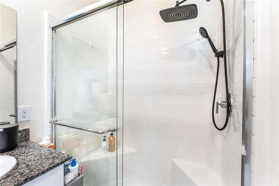 10947 Artisan Ranch Avenue Las Vegas, NV 89166 - Photo 20 of 39 Full bathroom featuring a stall shower and vanity
