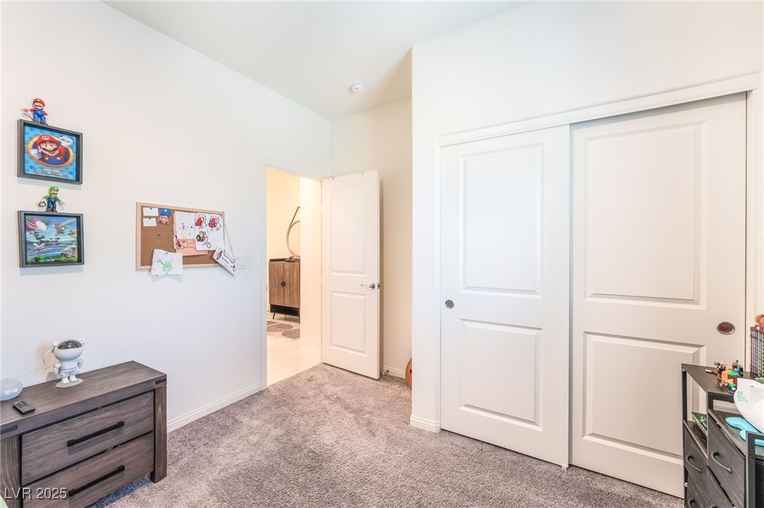 10947 Artisan Ranch Avenue Las Vegas, NV 89166 - Photo 25 of 39 Carpeted bedroom with a closet and baseboards