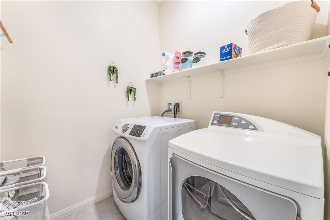 10947 Artisan Ranch Avenue Las Vegas, NV 89166 - Photo 29 of 39 Laundry room featuring washer and dryer and baseboards