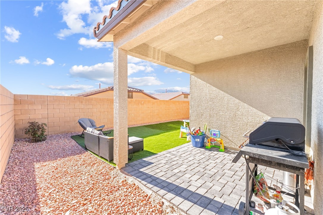 10947 Artisan Ranch Avenue Las Vegas, NV 89166 - Photo 30 of 39 Fenced backyard featuring a patio, grilling area, and an outdoor hangout area