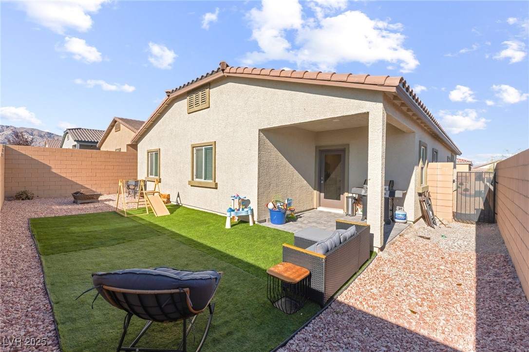 10947 Artisan Ranch Avenue Las Vegas, NV 89166 - Photo 32 of 39 Back of property featuring a fenced backyard, a patio, stucco siding, a gate, and a tiled roof