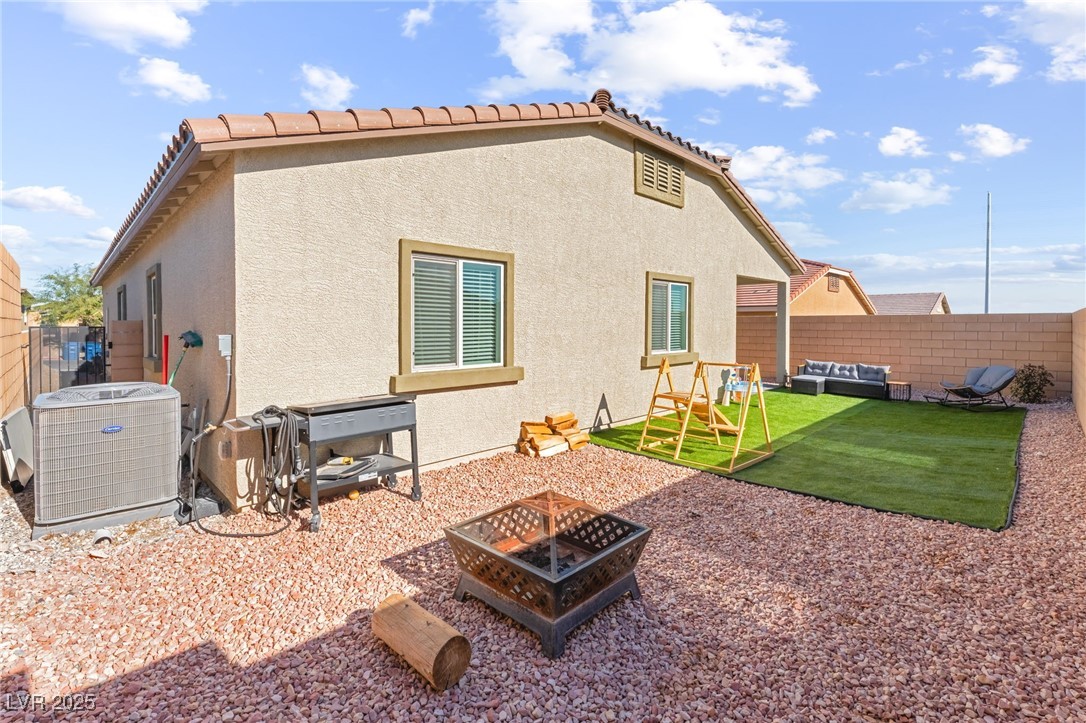10947 Artisan Ranch Avenue Las Vegas, NV 89166 - Photo 33 of 39 Back of property featuring a fenced backyard, stucco siding, and a patio area