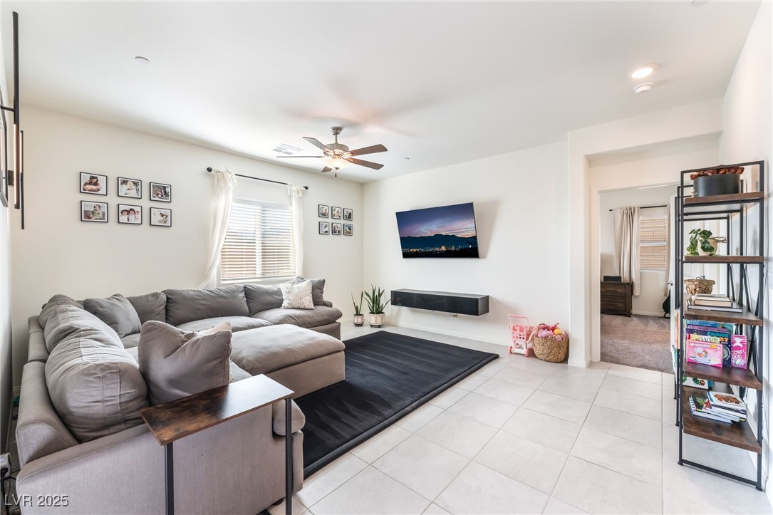 10947 Artisan Ranch Avenue Las Vegas, NV 89166 - Photo 5 of 39 Living area featuring a ceiling fan and light tile patterned flooring
