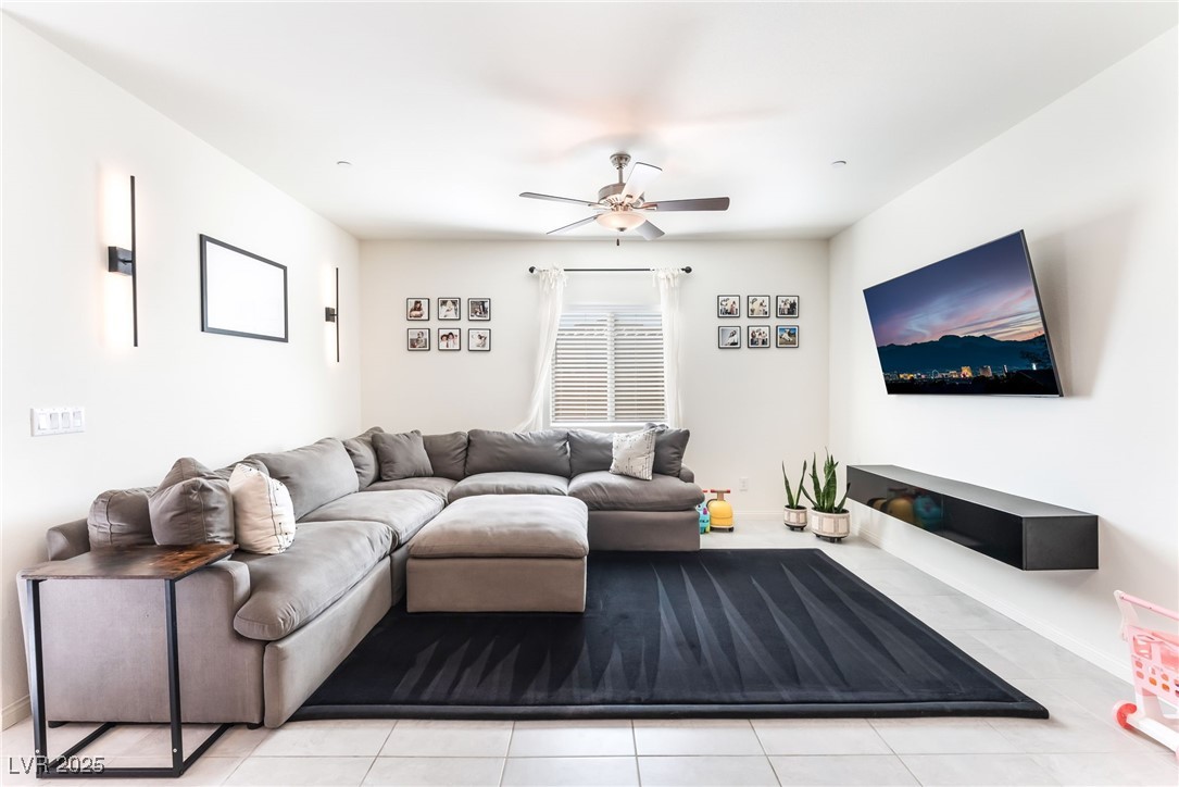 10947 Artisan Ranch Avenue Las Vegas, NV 89166 - Photo 6 of 39 Living area featuring ceiling fan and light tile patterned floors