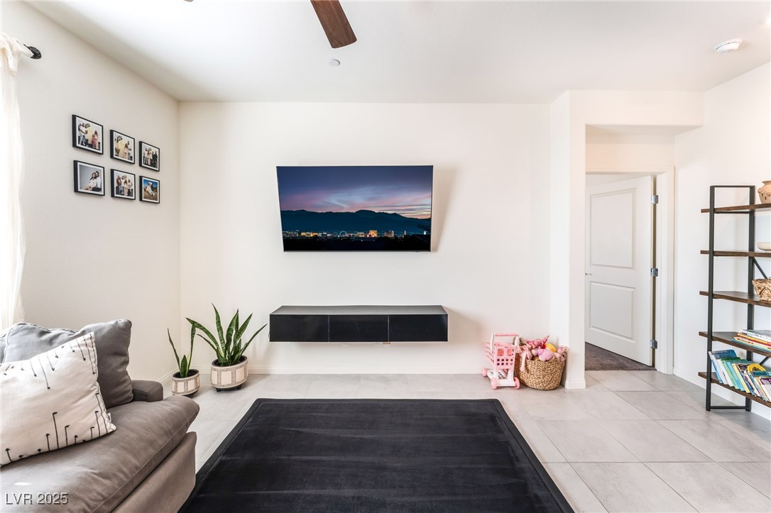 10947 Artisan Ranch Avenue Las Vegas, NV 89166 - Photo 9 of 39 Tiled living area featuring ceiling fan