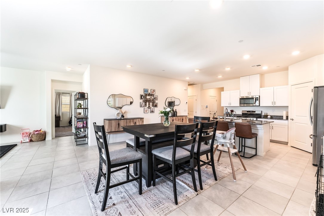 10947 Artisan Ranch Avenue Las Vegas, NV 89166 - Photo 10 of 39 Dining space featuring recessed lighting and light tile patterned floors
