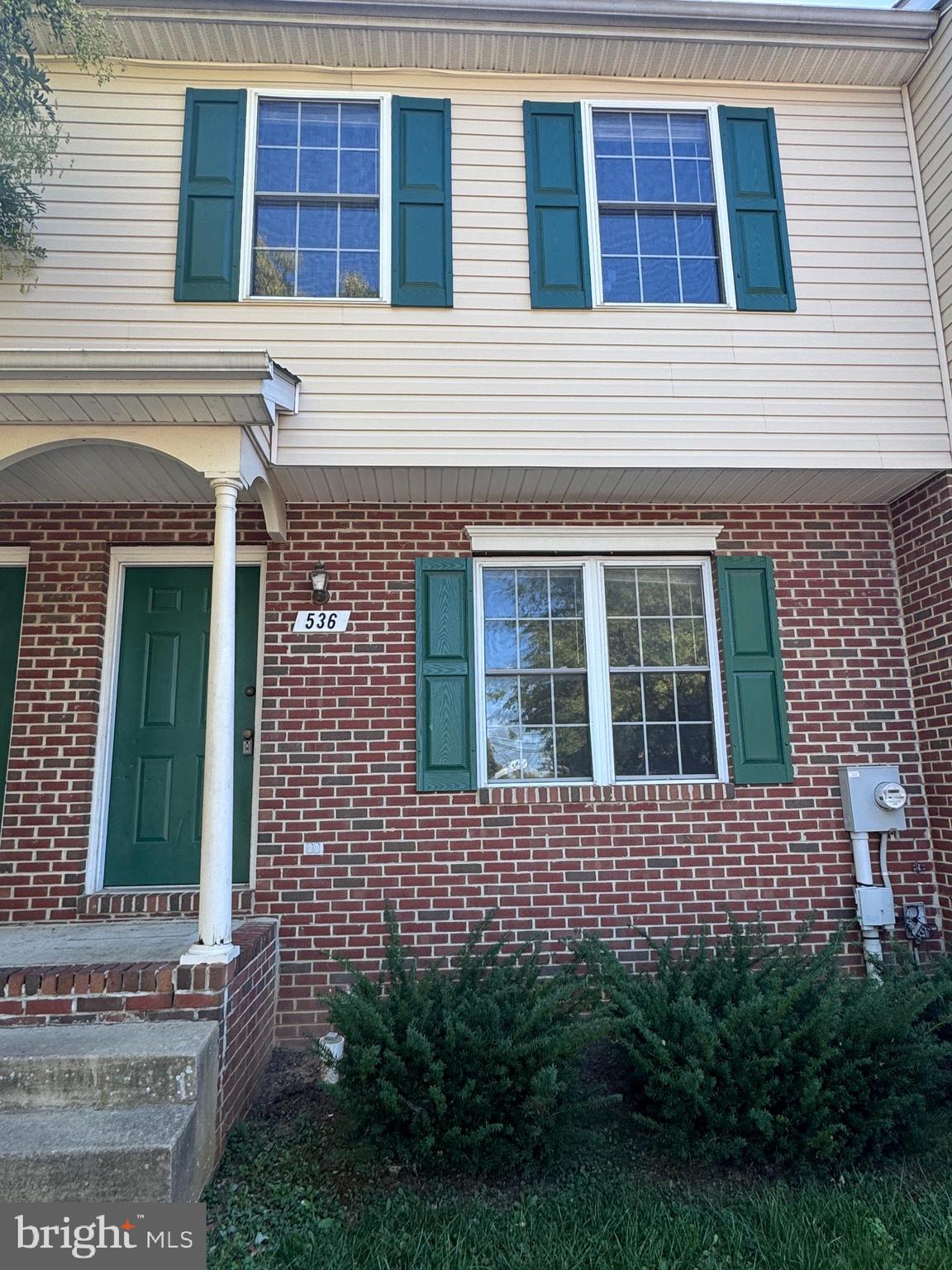 a view of a brick house with a large windows