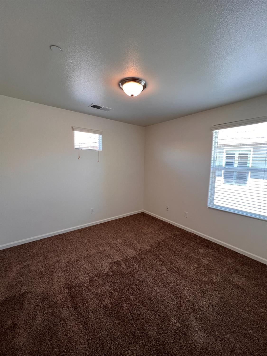 1504 Mosaic Way Clovis, CA 93619 - Photo 16 of 34 an empty room with a empty space and windows