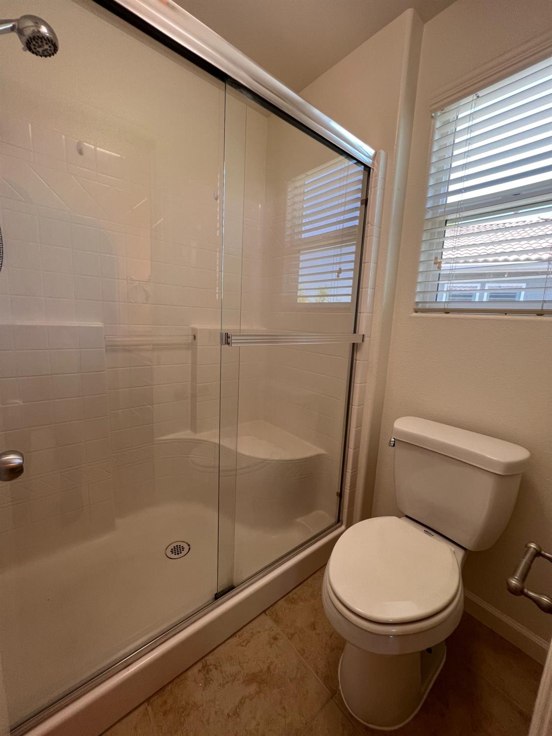1504 Mosaic Way Clovis, CA 93619 - Photo 27 of 34 a bathroom with a toilet and a shower