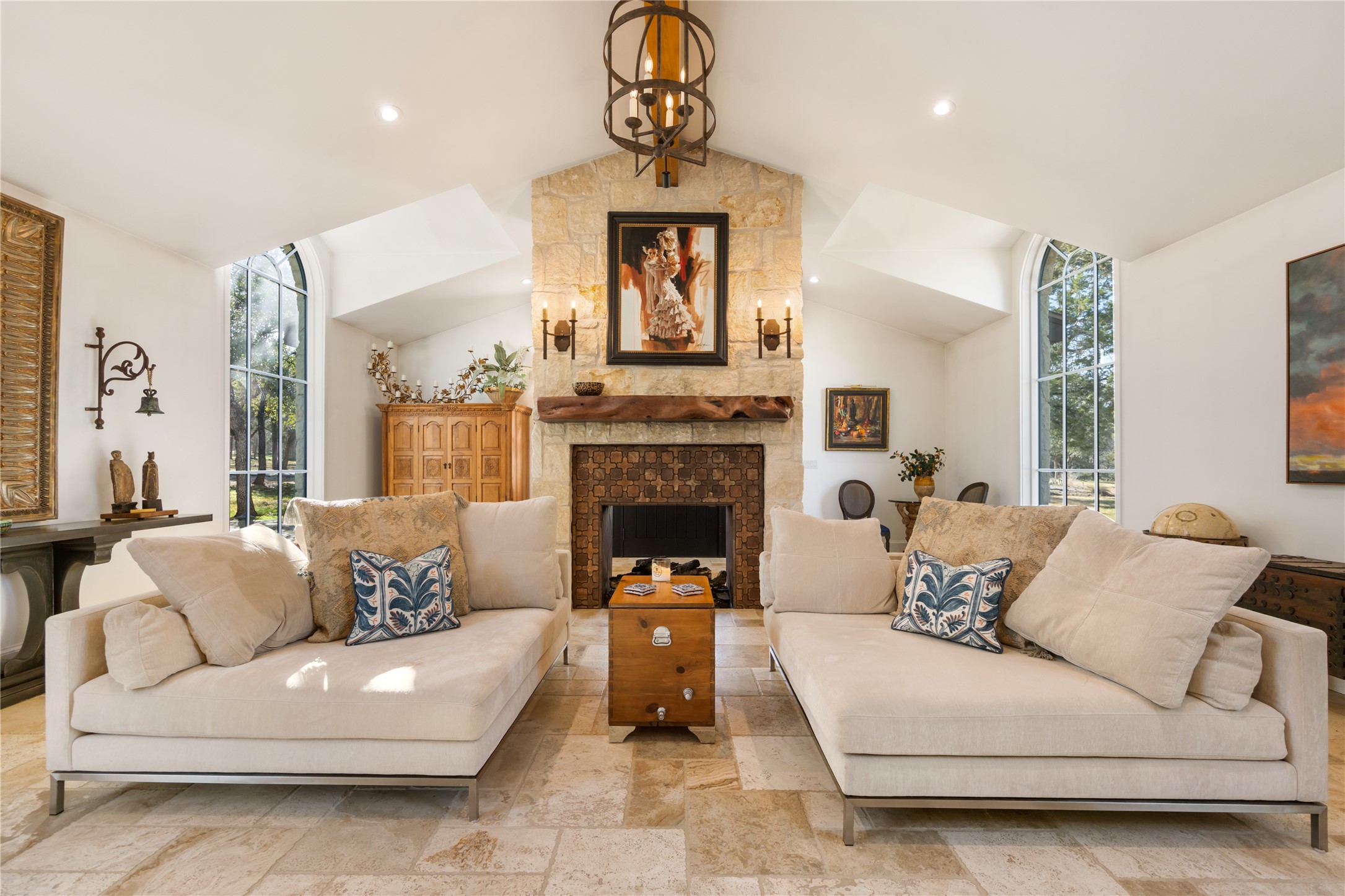 11941 Overlook Pass Austin, TX 78738 - Photo 10 of 40 Vaulted ceiling living area featuring a stone-clad fireplace with a natural wood mantel
