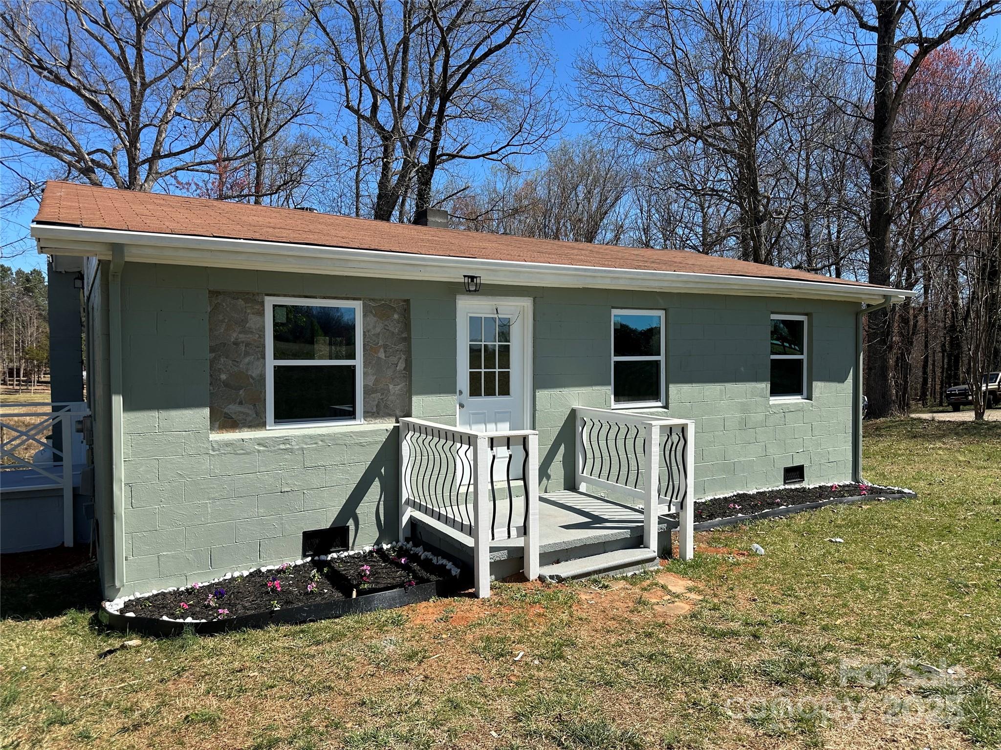 a view of backyard with deck and a large tree
