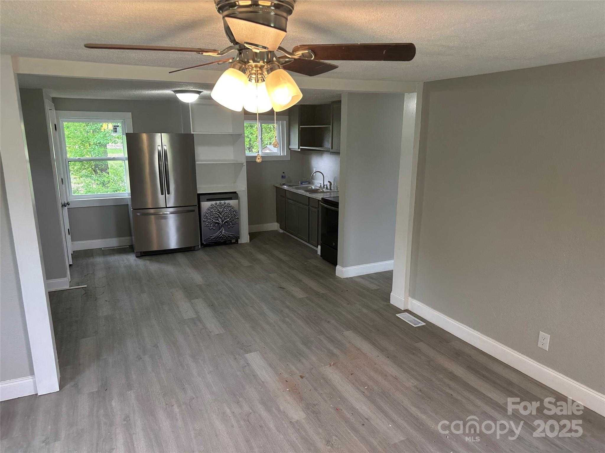 209 Brookview Road Statesville, NC 28625 - Photo 3 of 14 a kitchen with stainless steel appliances granite countertop a sink cabinets and wooden floor