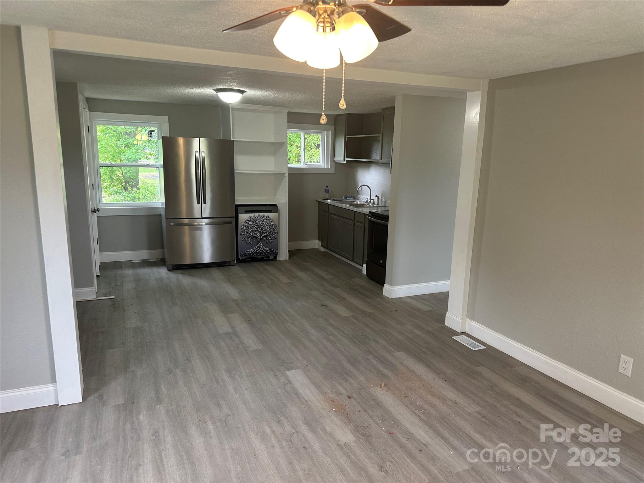 209 Brookview Road Statesville, NC 28625 - Photo 4 of 14 a kitchen with stainless steel appliances a refrigerator and a wooden floor