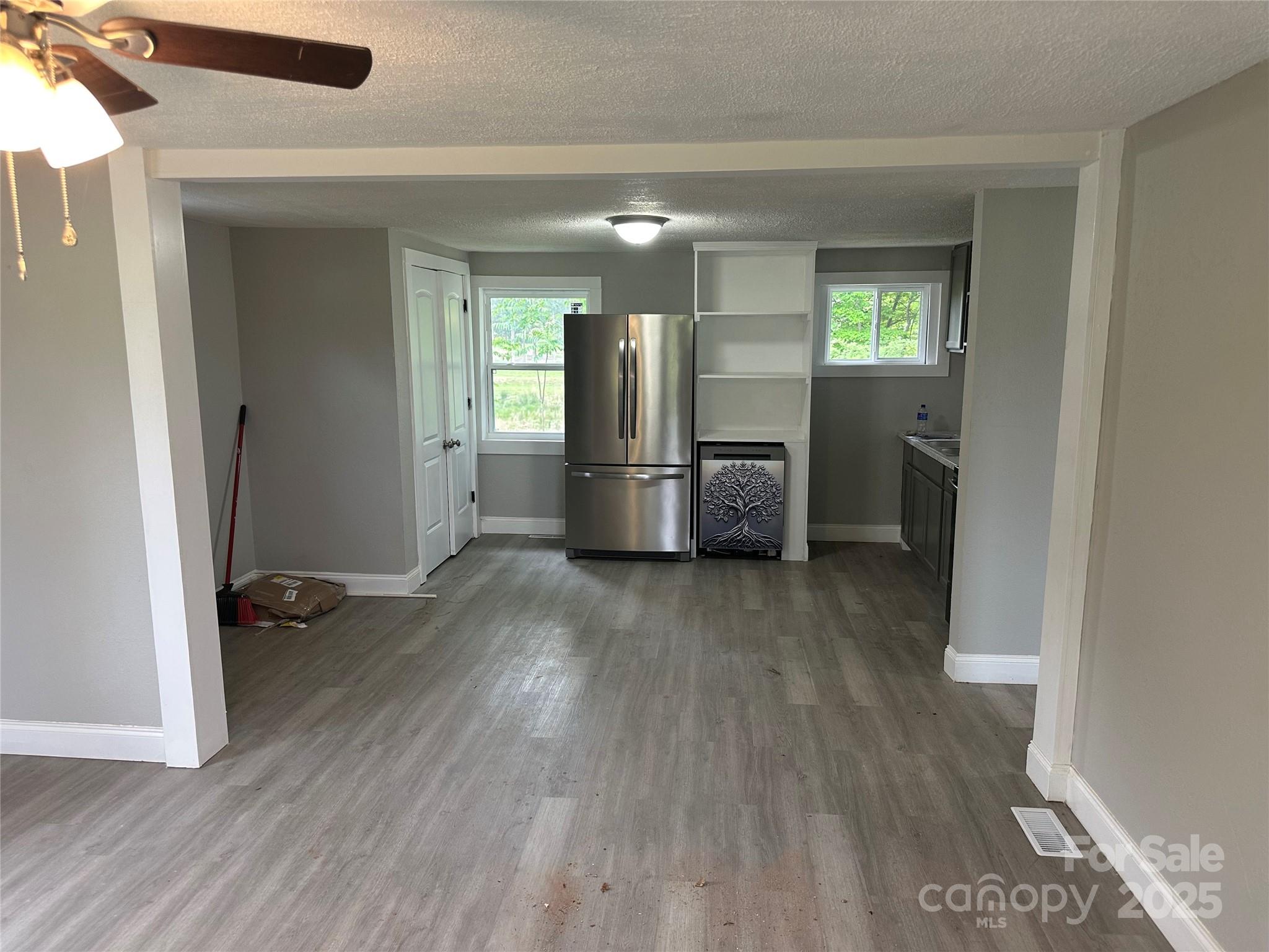 209 Brookview Road Statesville, NC 28625 - Photo 5 of 14 wooden floor in kitchen and an empty room with a window