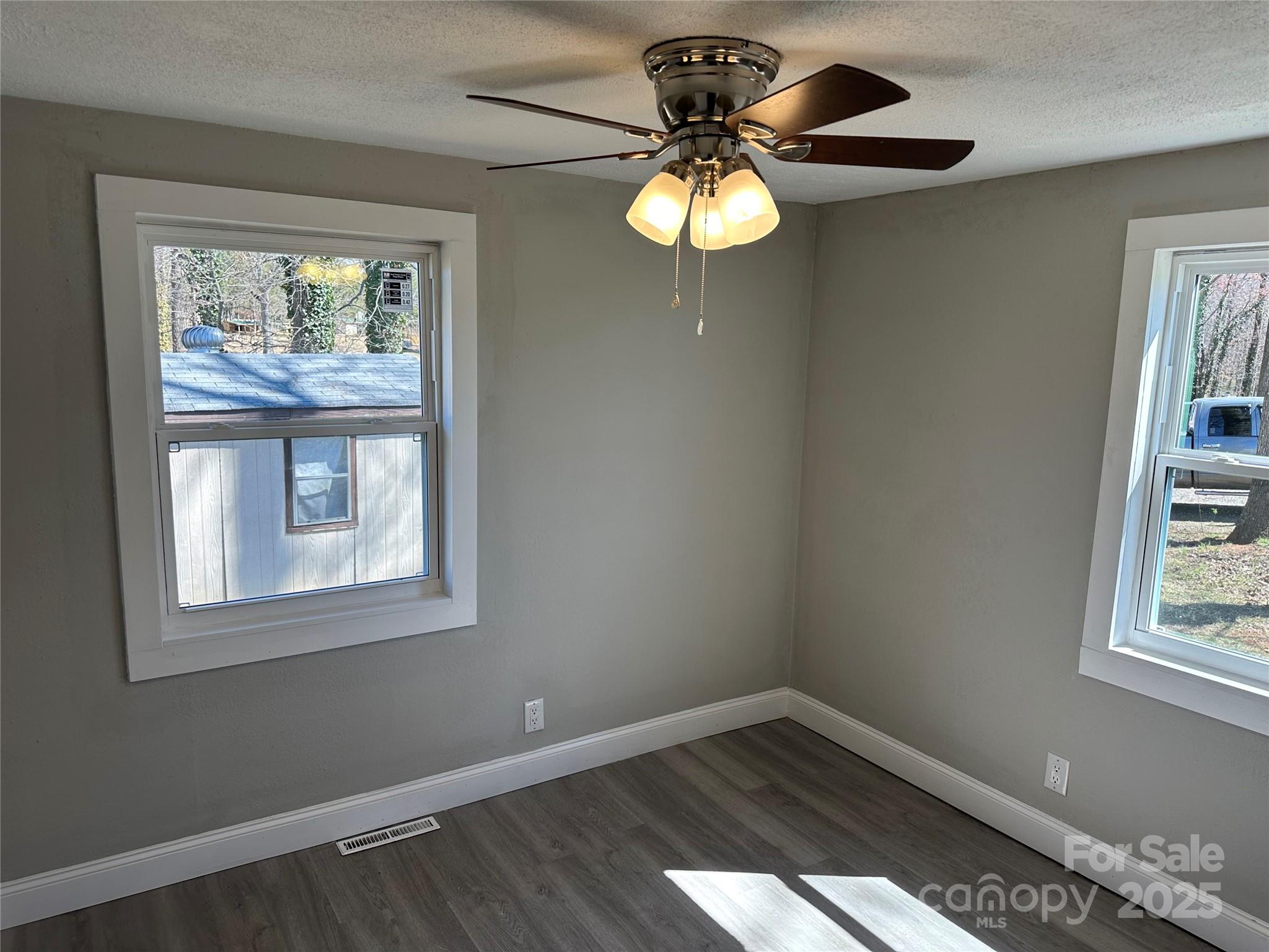 209 Brookview Road Statesville, NC 28625 - Photo 7 of 14 an empty room with windows and fan